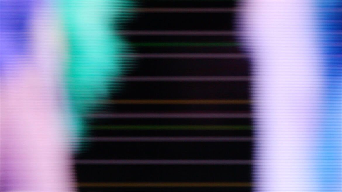 Dense mosaic of defocused coloured lights creating an abstract pattern
