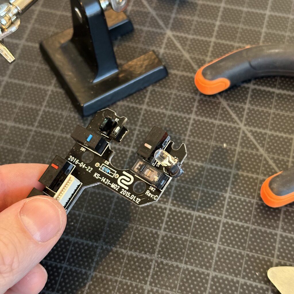 The gaming mouse fully reassembled after the switch replacement, ready for testing