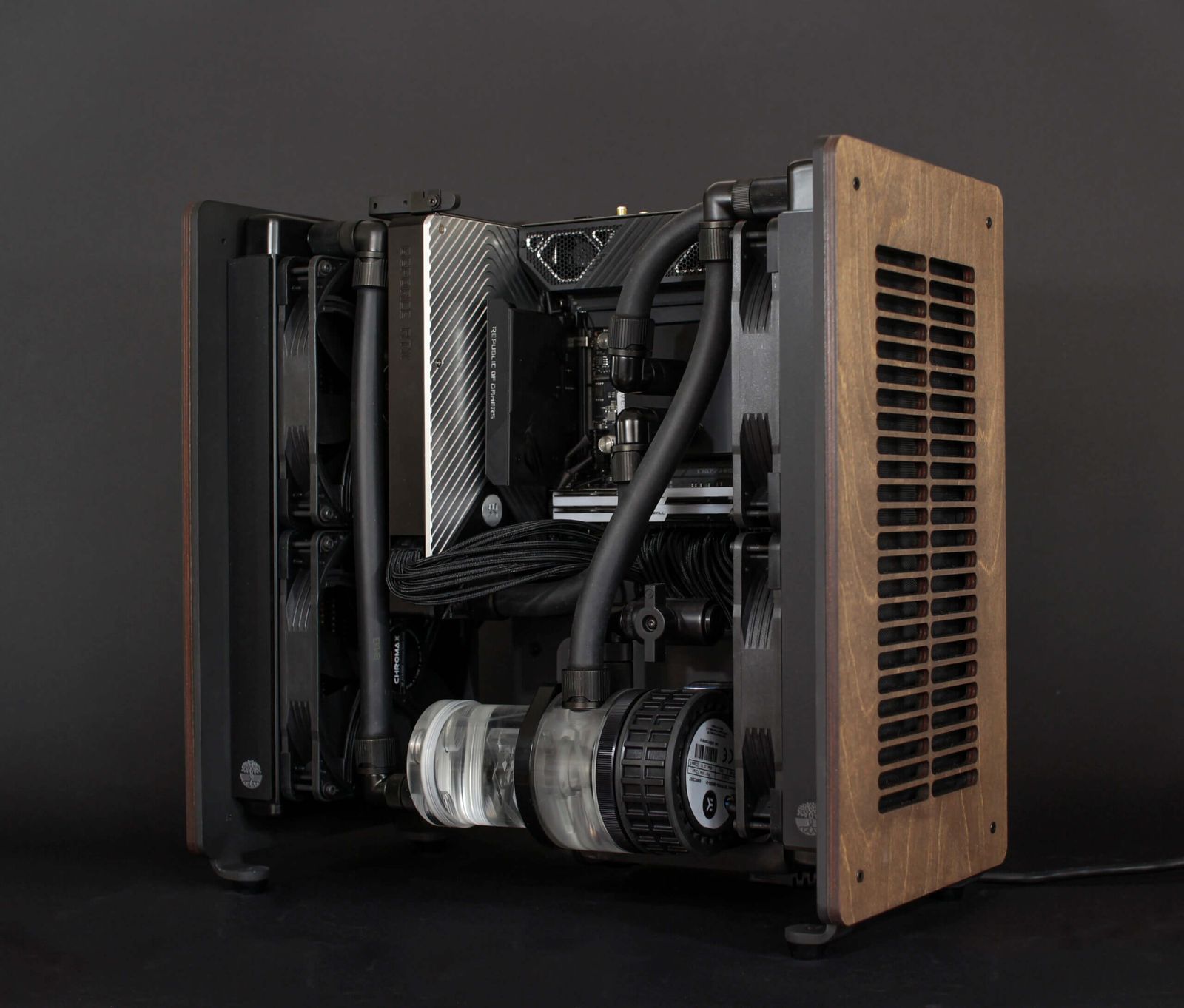 Tilia computer case with side panel removed, showing custom watercooling loop and internal components